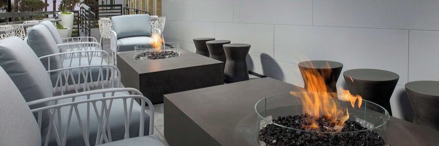 Modern outdoor lounge area at Element by Marriott Jacksonville Beach featuring stylish seating and fire pits.