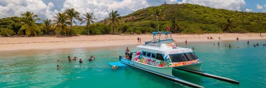 Catamaran anchored in turquoise water near a sandy beach in Culebra, Puerto Rico
