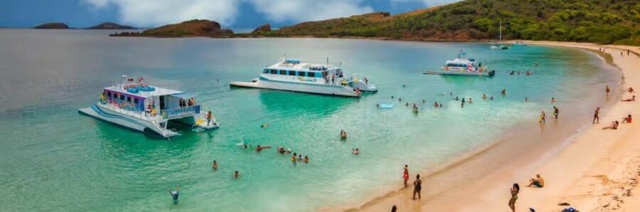 Snorkelers enjoying clear turquoise water near anchored boats off the coast of Culebra, Puerto Rico