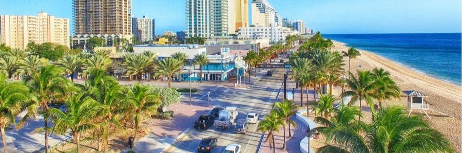Fort Lauderdale beach lined with palm trees, hotels, and the Atlantic Ocean