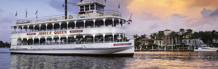 Jungle Queen sightseeing boat cruising along Fort Lauderdale's scenic canals at sunset.