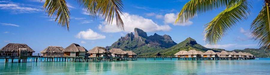 Overwater bungalows in French Polynesia with Mount Otemanu and turquoise lagoon