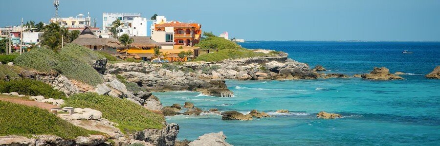 Rocky Coastline on Isla Mujeres | Beach Travel Destinations Rocky Caribbean coastline with turquoise water on Isla Mujeres, Mexico.
