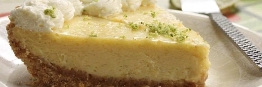 Creamy slice of traditional Key lime pie topped with whipped cream and fresh lime zest in Key West Florida.
