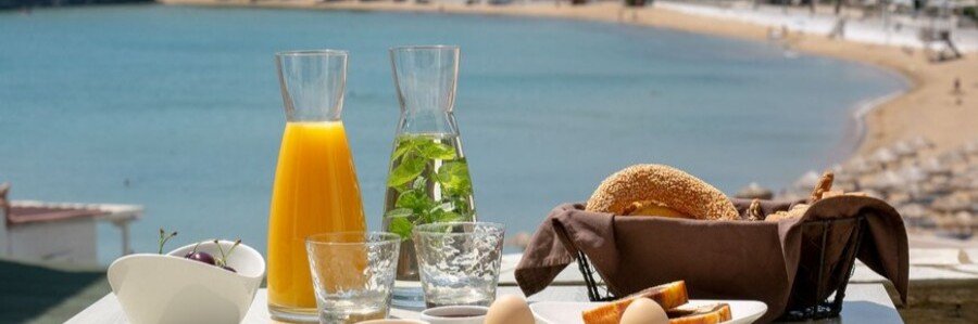 Breakfast with sea views from Krinos Suites overlooking Batsi Bay on Andros, Greece.