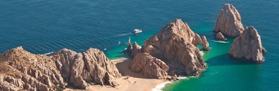 Aerial view of Land’s End, El Arco, rocky cliffs and turquoise water at the tip of the Baja Peninsula.