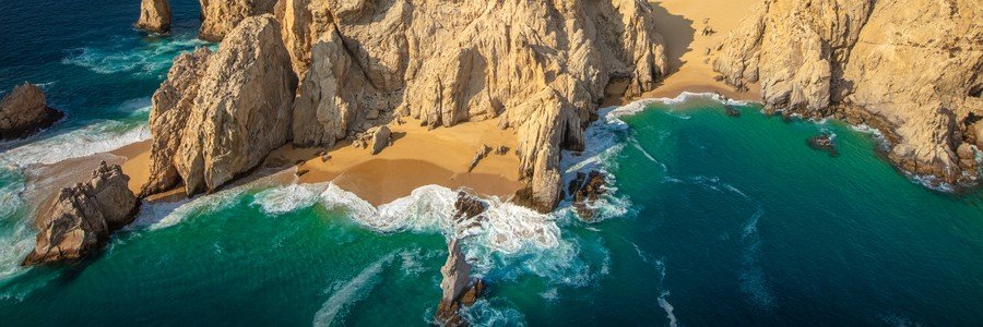 Aerial view of Cabo Beaches at Lover’s Beach surrounded by granite cliffs and turquoise water