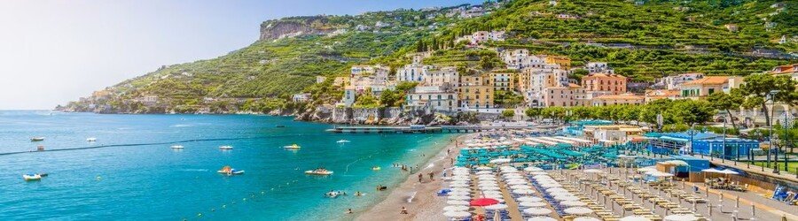 Colorful umbrellas line Minori Beach along the Amalfi Coast near Naples