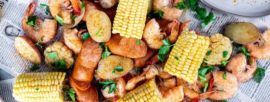 Traditional shrimp boil with corn, sausage, and potatoes served family-style on Mustang Island Texas.