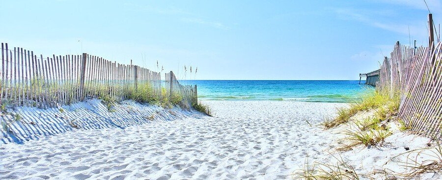 Navarre Beach Florida public access path with white sand dunes, fencing, and Gulf Coast shoreline