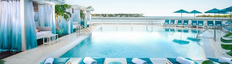 Luxury waterfront pool at Ocean Key Resort & Spa in Key West overlooking turquoise ocean views and tropical cabanas.