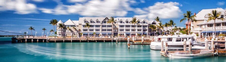 Waterfront marina view at Opal Key Resort & Marina in Key West with boats, tropical architecture, and turquoise water.