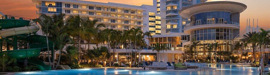 Pier Sixty-Six resort at sunset with luxury pools, marina, and waterfront views in Fort Lauderdale.