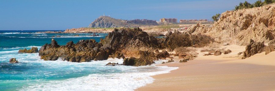 Cabo Beaches at Playa Las Viudas with turquoise waves, golden sand, and rugged rock formations