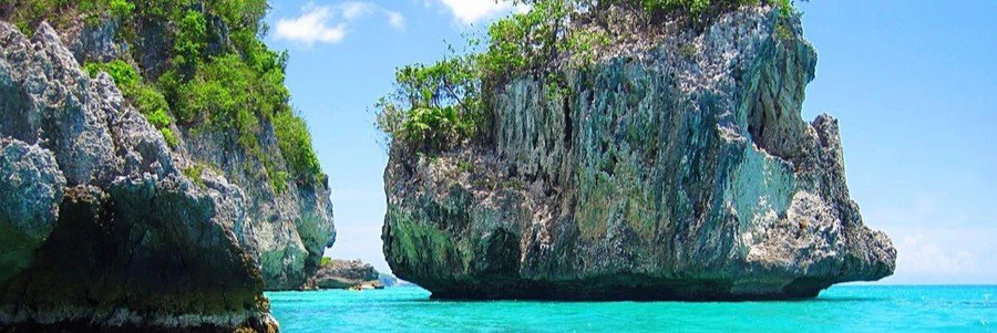 Turquoise Caribbean water flowing between large limestone formations near Port-Salut in southern Haiti.
