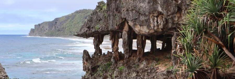 Dramatic coastal cliffs and unique rock formations along the shoreline of Rurutu in the Austral Islands