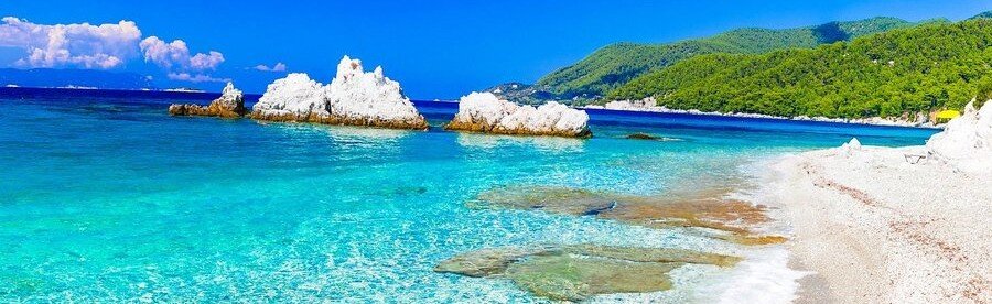 Turquoise water and white rock formations along a beautiful beach on Skopelos Island Greece