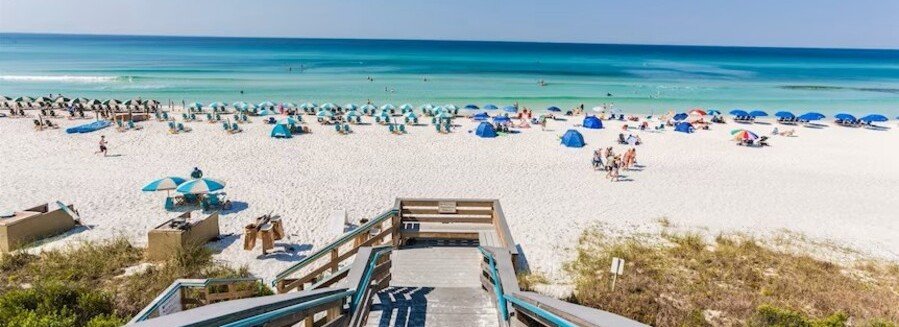 South Walton 30A beach in Florida with white sand, turquoise water, and beach umbrellas viewed from boardwalk access