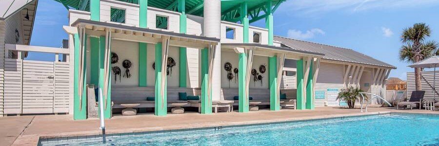 Modern coastal pool area at Sunflower Beach Resort with turquoise architecture and luxury vacation residences.