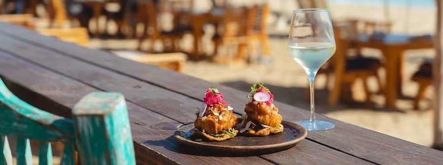 The Green Room beachfront restaurant in Todos Santos Mexico with ocean views, palm trees, and relaxed Baja coastal atmosphere