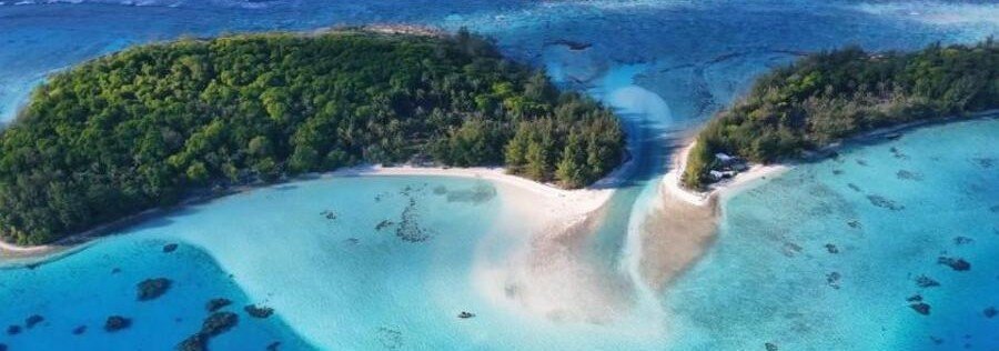 Aerial view of Tubuai lagoon with white sandbar, turquoise water, and lush tropical islets in the Austral Islands
