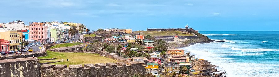 Colorful buildings and historic fortifications overlooking the coastline in San Juan, Puerto Rico.
