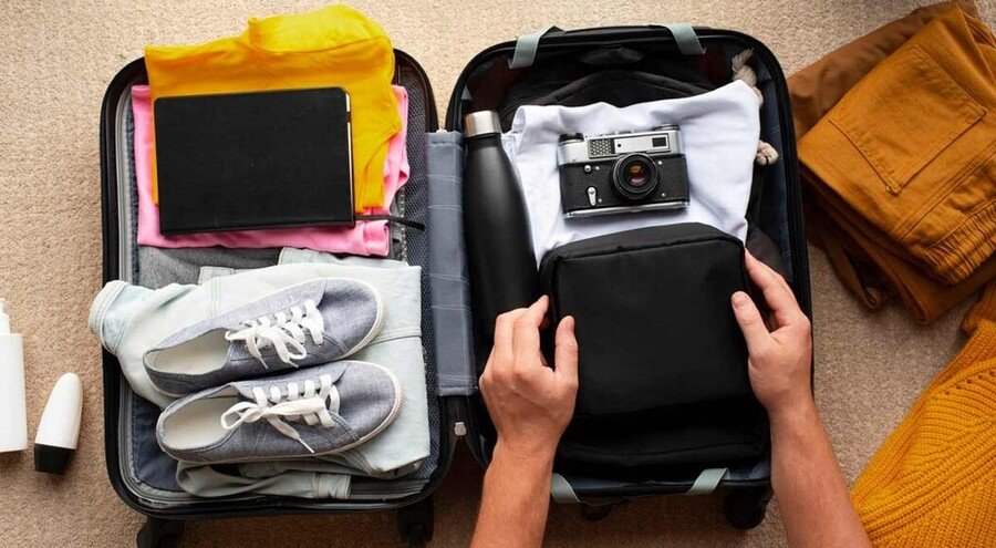 A vibrant travel flat lay featuring a passport, camera, phone, shoes, sunglasses, and travel accessories. This image reflects the spirit of travel adventure and thoughtful traveler gift inspiration.