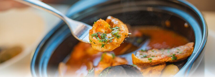 Fort Myers coastal seafood dish with shrimp and shellfish in savory broth