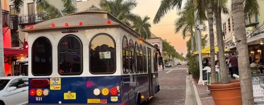 Fort Myers downtown trolley street scene with palm trees and shops