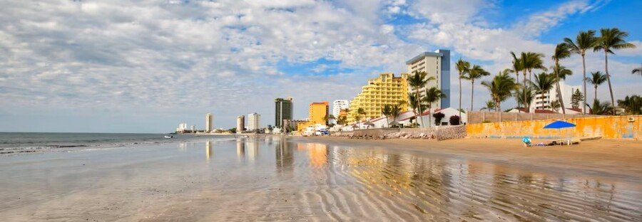 Mazatlán Playa Cerritos beach with hotels and palm trees along the Mexican Riviera cruise coastline