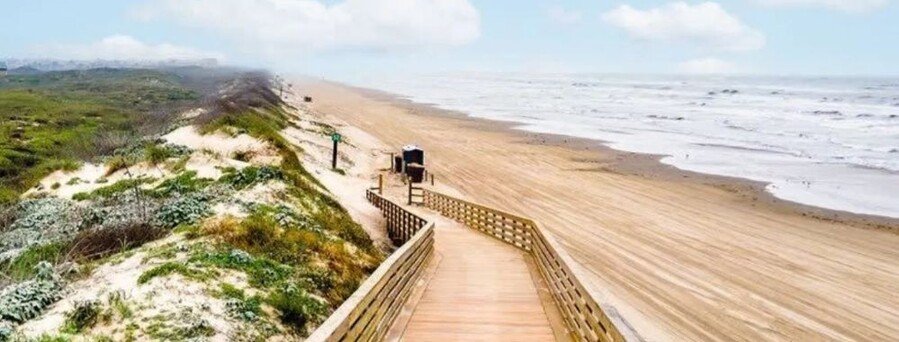 San José Island Texas beach with wooden boardwalk, coastal dunes, and wide Gulf shoreline