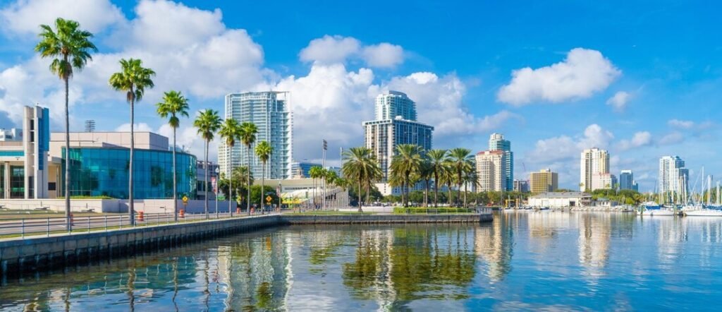 St Pete Florida waterfront skyline with palm trees, marina, and modern buildings along Tampa Bay