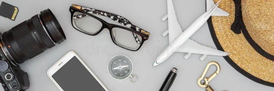 Travel flat lay with airplane model, camera, phone, hat, glasses, and travel accessories on a neutral background