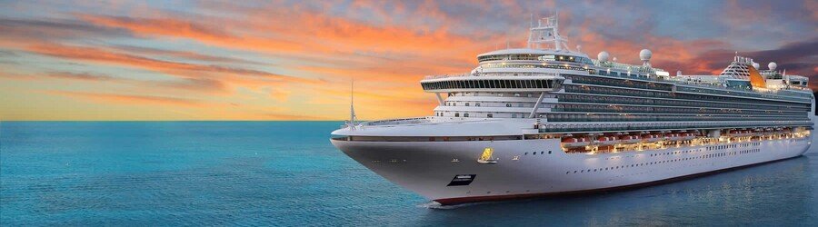 Large cruise ship sailing across the ocean during a colorful sunset