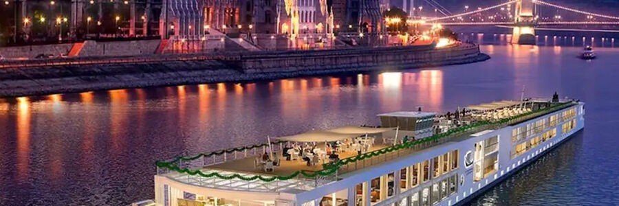 Danube Christmas market cruise ship decorated for the holidays in Budapest at night.
