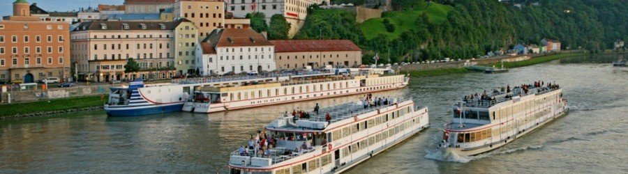 River cruise ships docked along the Danube River in Linz, Austria, near the historic city center.