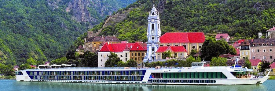 Danube River cruise ship sailing through Austria's scenic Wachau Valley.