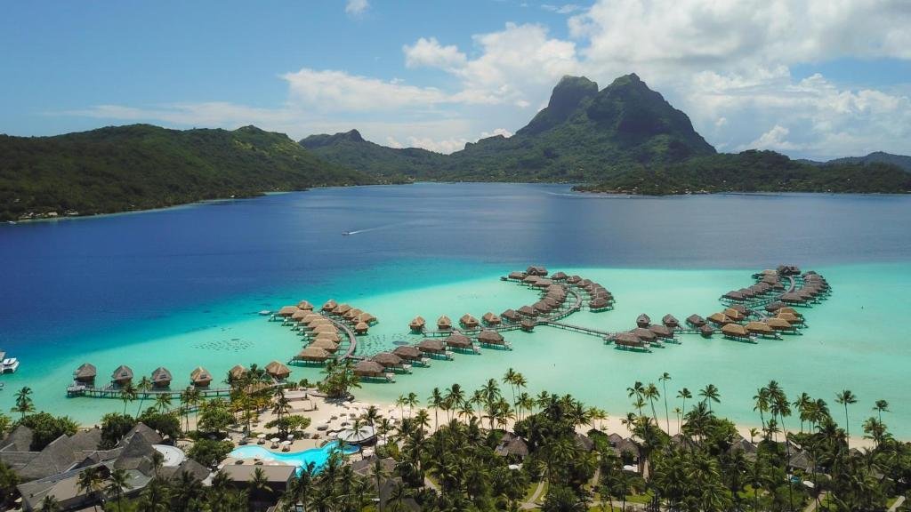 Le Bora Bora by Pearl Resorts overwater bungalows, villa interior, and private pool with tropical mountain views