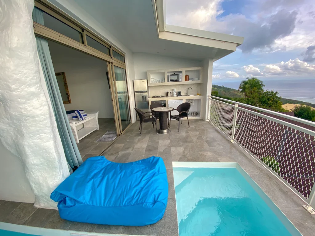 Hillside guesthouse in Tahiti with ocean views, terrace plunge pool, and bright interior room