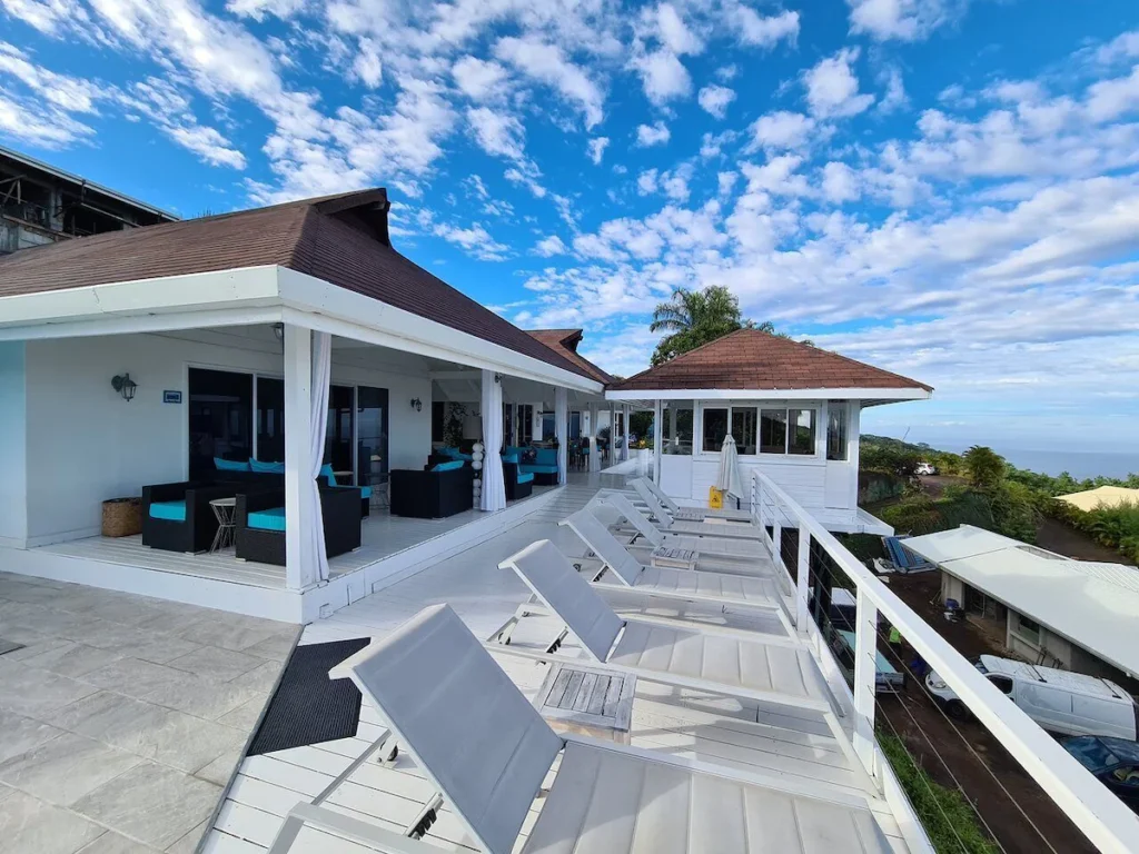 Hillside guesthouse in Tahiti with ocean views, terrace plunge pool, and bright interior room