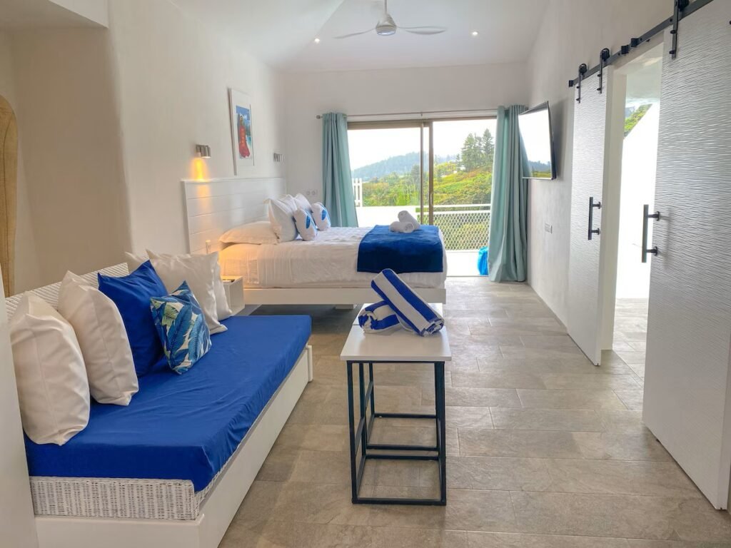 Hillside guesthouse in Tahiti with ocean views, terrace plunge pool, and bright interior room