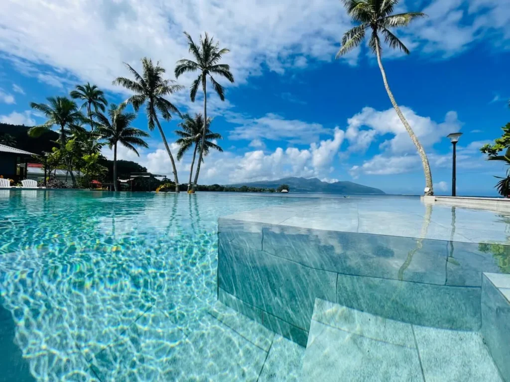Boutique beachfront retreat in Tahiti with private villas, pool, and tropical surroundings