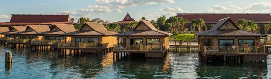 Overwater bungalows in Bora Bora lagoon with wooden villas on stilts above calm tropical water