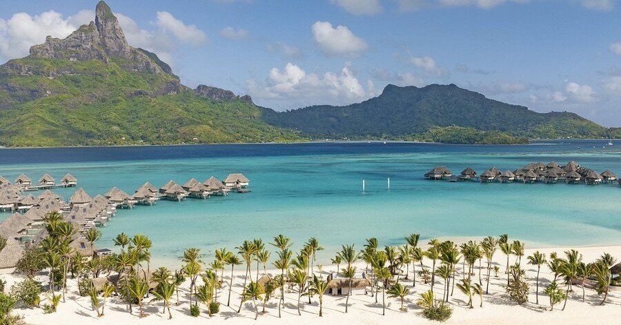 Overwater bungalows in Bora Bora with Mount Otemanu and turquoise lagoon in French Polynesia