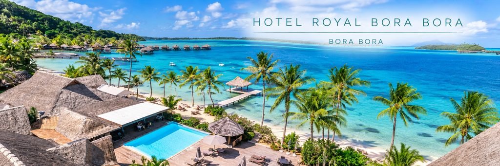 Aerial view of Hotel Royal Bora Bora featuring a beachfront swimming pool, palm-lined white-sand beach, thatched-roof buildings, and turquoise lagoon waters.
