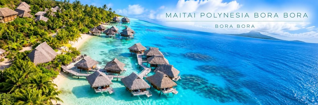 Aerial view of Maitai Polynesia Bora Bora featuring traditional thatched-roof overwater bungalows, wooden walkways, lush tropical palms, and crystal-clear turquoise lagoon waters.