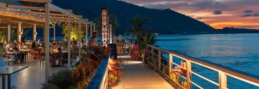 Beachfront restaurant in Moorea at sunset overlooking Cooks Bay with ocean views and outdoor dining