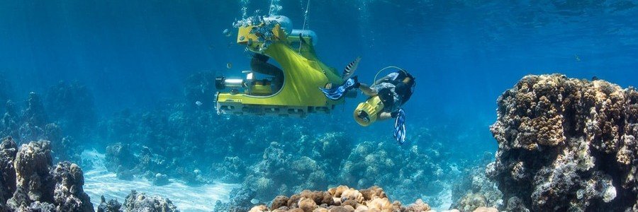 Underwater sea scooter tour in Moorea exploring vibrant coral reef and marine life