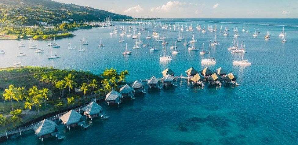 Aerial view of Tahiti lagoon with boats and overwater bungalows