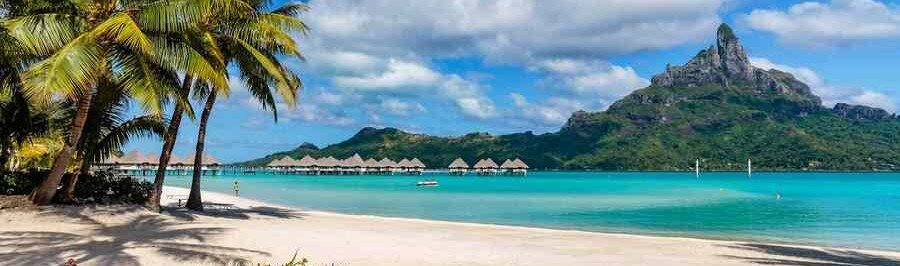 Toaroto Beach in Tahiti with turquoise lagoon, palm trees, and mountain views